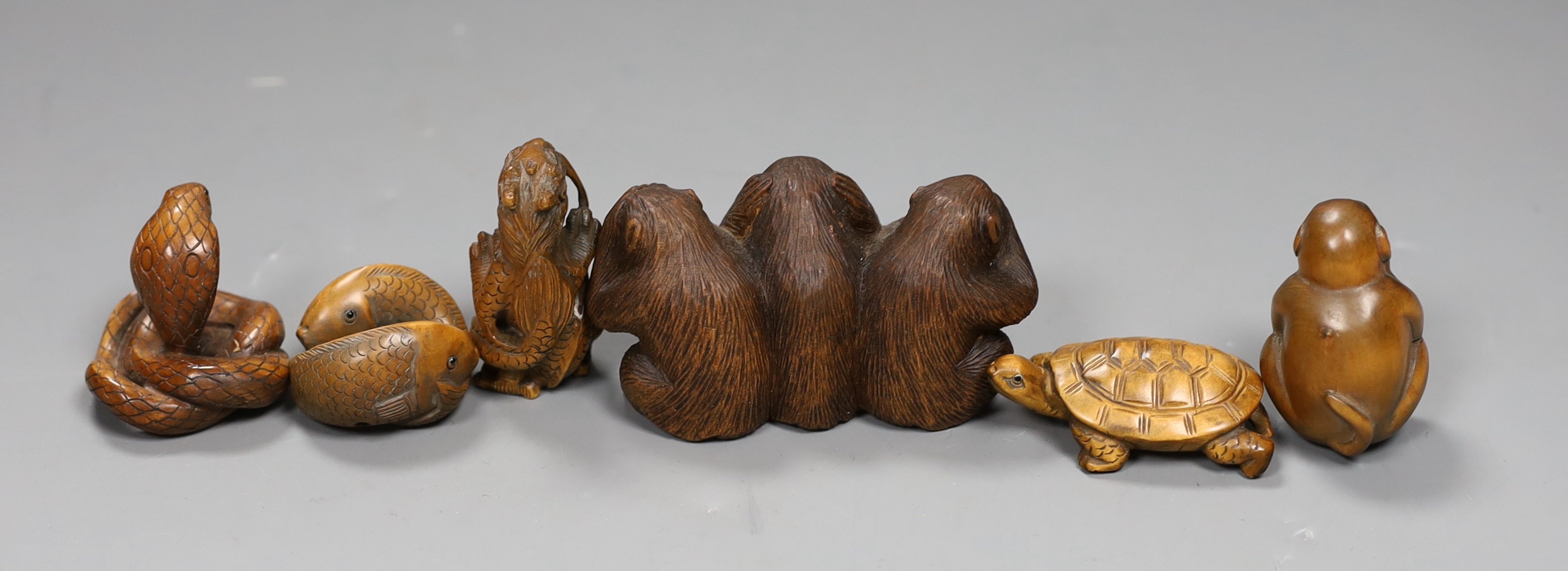 Five wooden animal netsuke; koi, cobra, monkey, tortoise, hear no, see no, say no monkey group, together with a carved wooden figure of a dragon, tallest 5cm